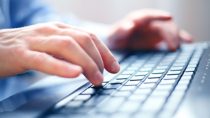 Image of man's hands typing. Selective focus