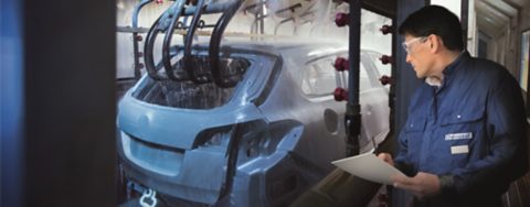 Car bodies being cleaned prior to spraying in car factory.