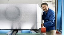 BASF employee in blue overalls pushing big block of styrofoam