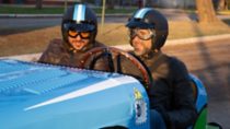 Two men in a vintage car with electric drive