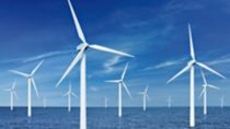White wind turbine in water with blue skies 