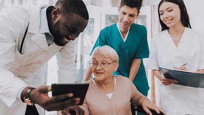 Syndromic Testing Doctor and nurses show test results to an old patient