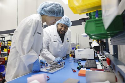 Two biomerieux employees work together