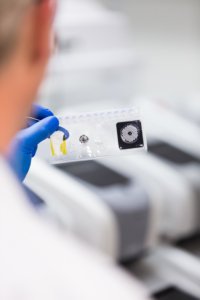 Person working in laboratory holds pouch