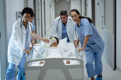 Medical team pushing emergency stretcher bed in the corridor