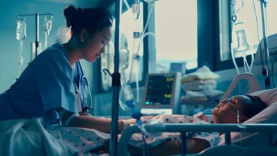 Young nurse in ICU carefully checking the vitals of an unconscious patient, demonstrating dedication and care in a high-stress medical environment.

•         Image provider: Adobe Stock
•         Image ID: 836415604
•         License: Extended use
