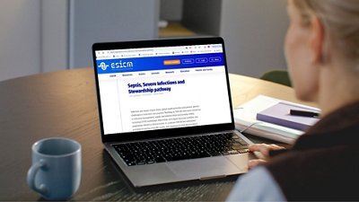 Visual of a person using a laptop to access educational content on sepsis, severe infections, and stewardship. The screen displays a structured learning pathway, highlighting digital medical education in a professional setting.