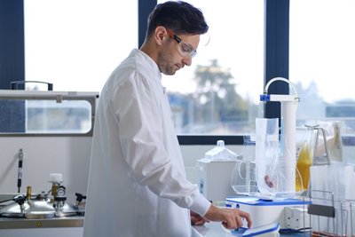 DILUMAT® instrument being used by Lab technician -- BLUE LINE - 2025 - SAMPLE PREPARATION - SAMPLE DILUTION- FOOD SAFETY AND QUALITY - GLOBAL INDUSTRIAL APPLICATIONS