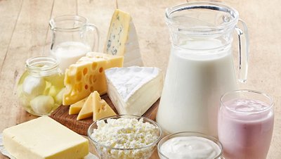 Various fresh dairy products on wooden background