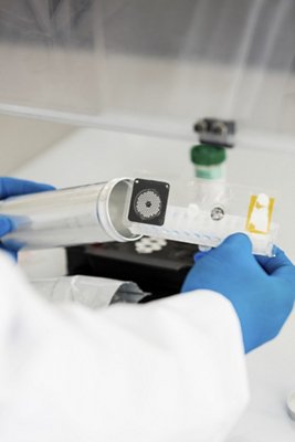 Person in laboratory holds BIOFIRE pouch