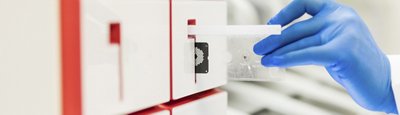 Gloved hand puts pouch into BIOFIRE 