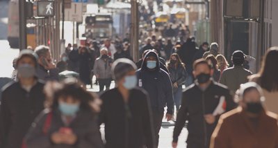 Anonymous crowd of people walking street wearing masks during covid 19 coronavirus pandemic, Anonymous crowd of people walking street wearing masks during co
