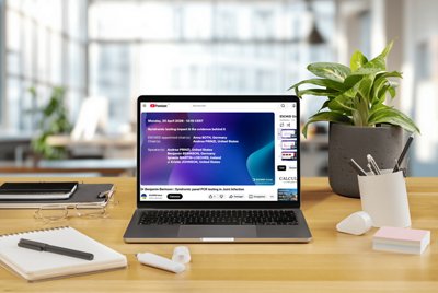 Laptop displaying a recorded ESCMID 2026 webinar on syndromic PCR testing in joint infection, featuring expert speakers and clinical insights. This educational content highlights the impact of syndromic testing on diagnosis and patient management in infectious diseases.