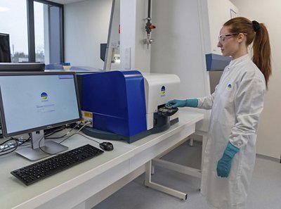 Lab woman operating a SCANRDI instrument in a lab