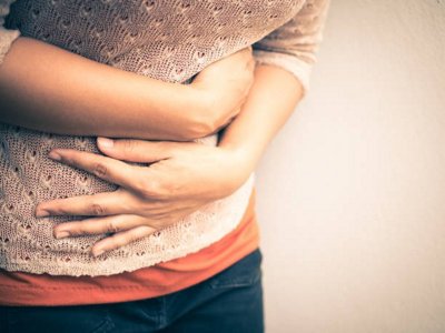 Person in pain, holding thier stomach