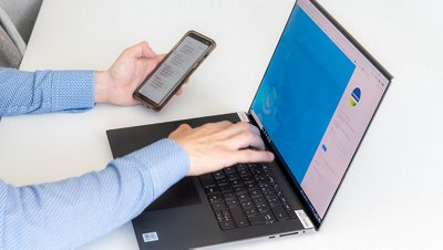 Person using computer and phone