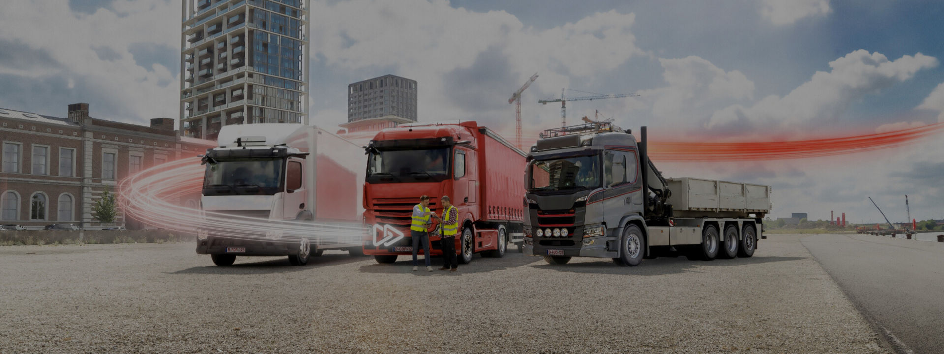 Three trucks on gravel bank.