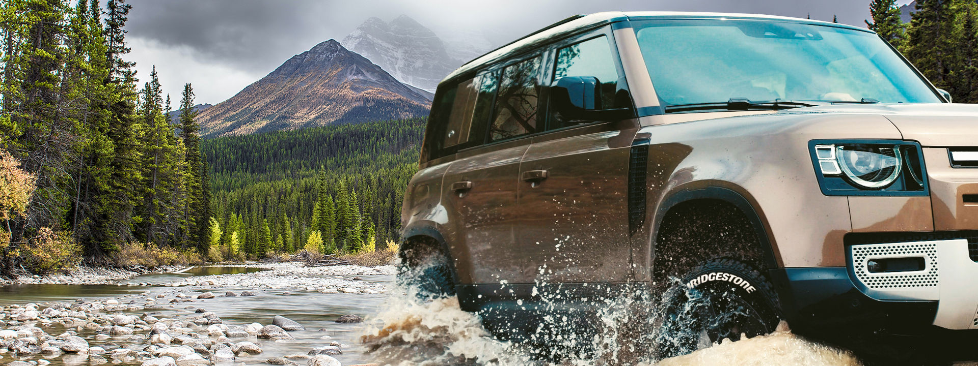 vehicle with 4x4 tyres travelling offroad on rocky terrain