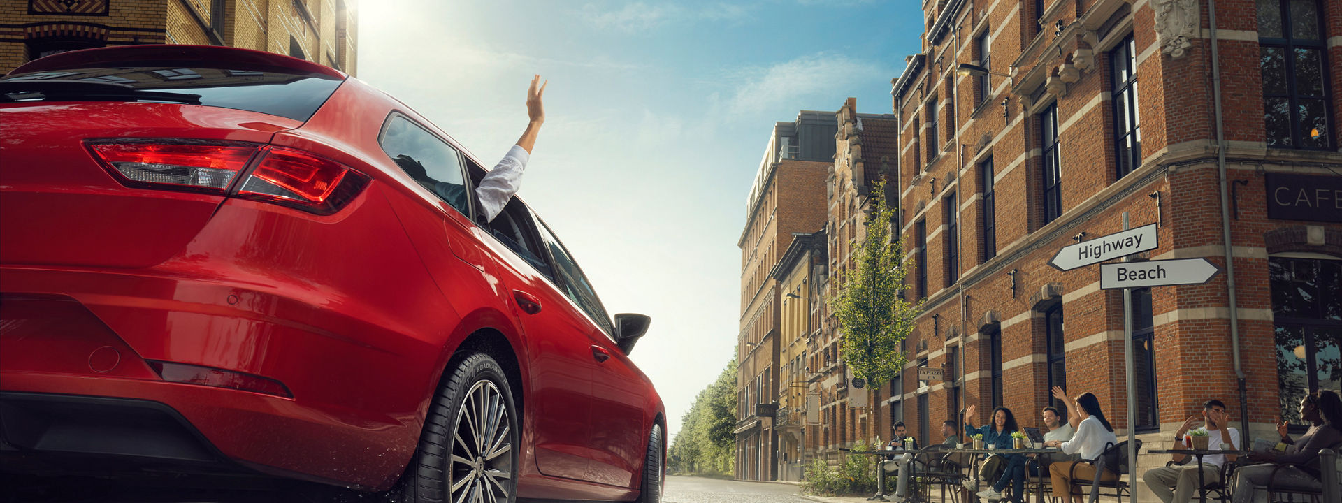 Friends enjoying a break away in a red car with Firestone tires.