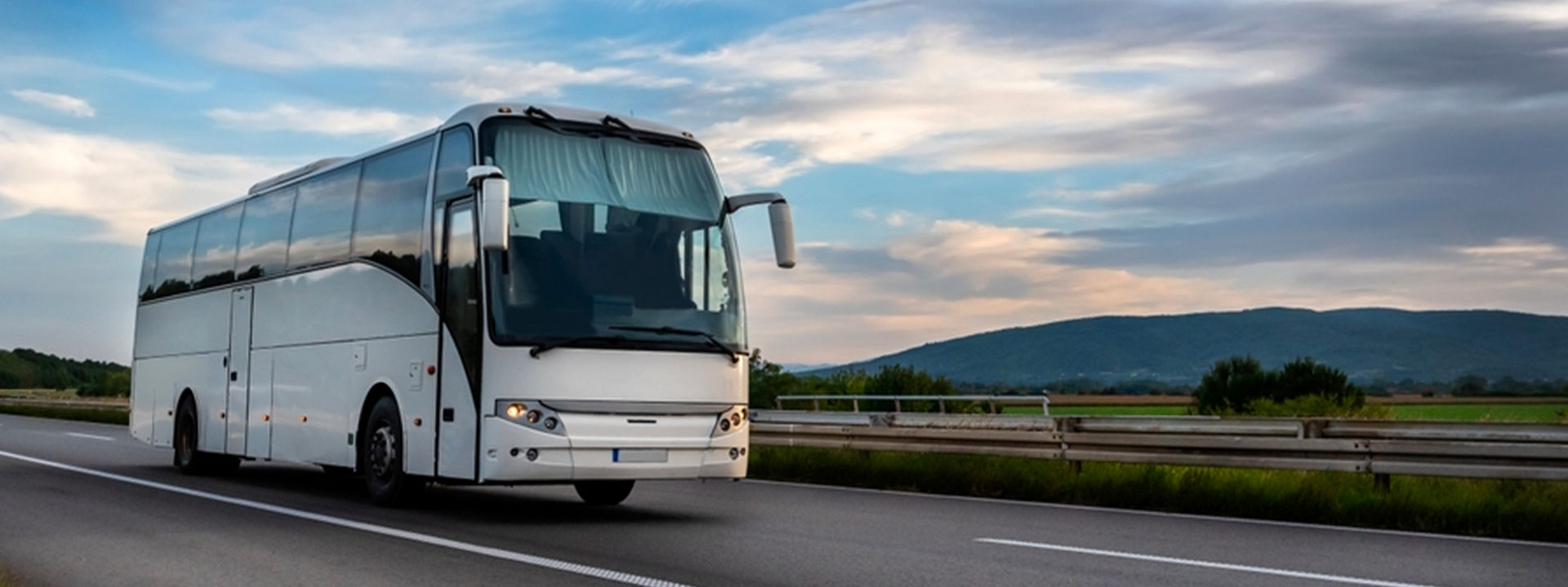 This image shows a bird's-eye view of a coach bus with Bridgestone coach tyres driving on the highway.