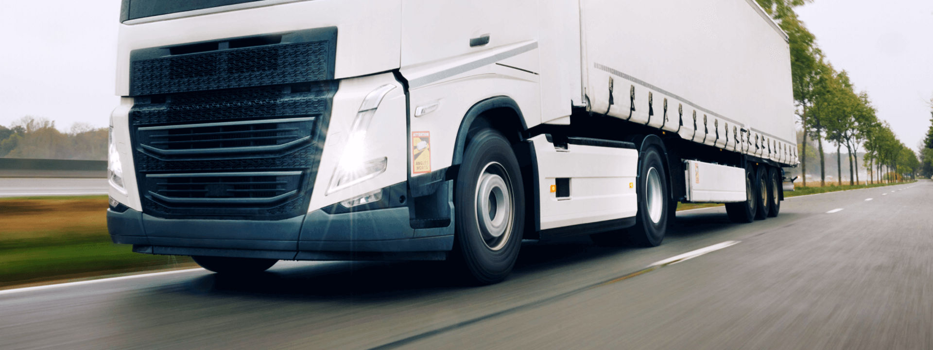 This image is a bird's-eye view of a commercial fleet travelling on a highway with Bridgestone highway tyres.