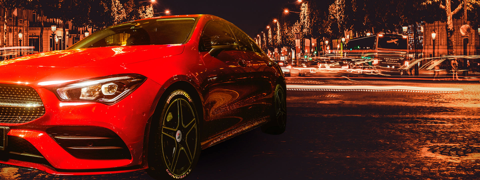 This image is a close-up of a Bridgestone Turanza tyre driving through wet conditions