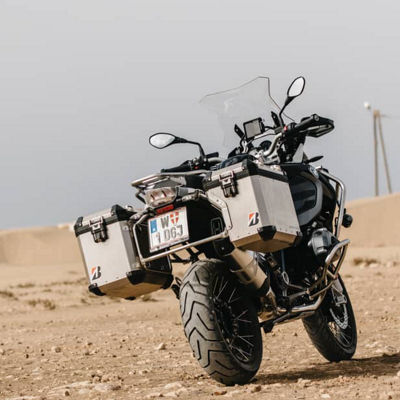 This image shows a back view of an adventure bike with Bridgestone adventure tyres
