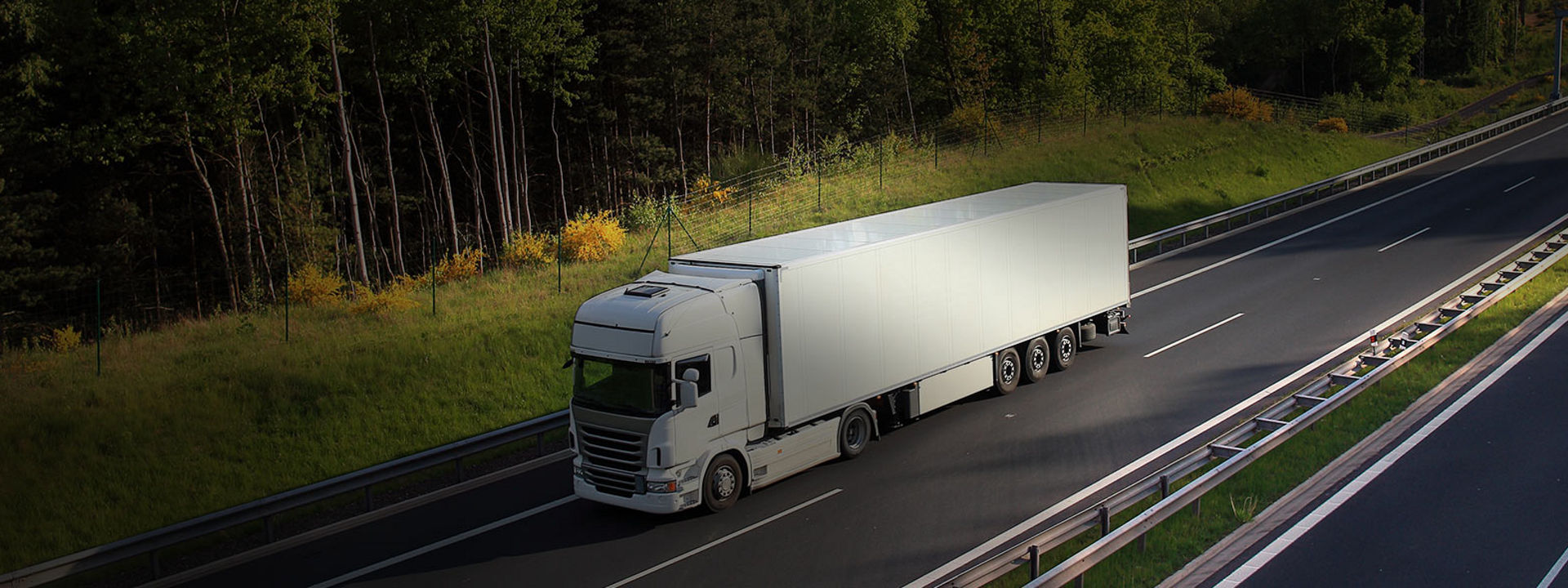 Billedet viser en lastvogn monteret med Bridgestone langtursdæk på en motorvej.