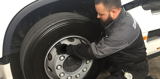 This image shows a Bridgestone operator installing Tirematics onto a fleet tyre. 