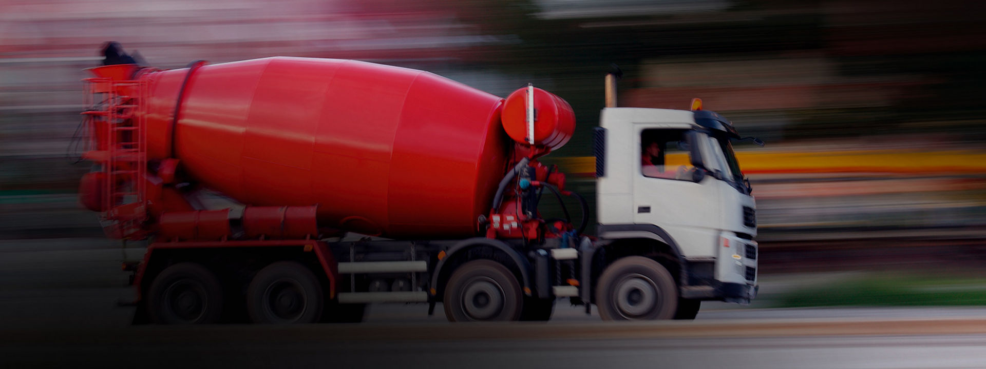 This image shows a cement truck with Bridgestone mild on/off road tyres driving on a highway to a worksite.