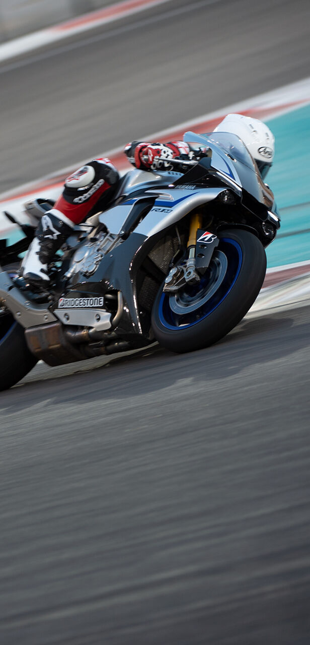 This image shows a close up of a motorcycle racer in a sharp corner counting on its Bridgestone tyres.