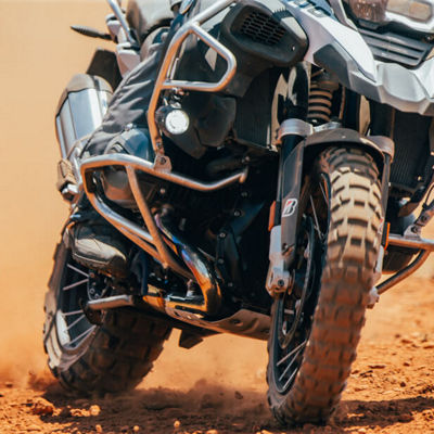 This image shows a close up of the Bridgestone Battlax Adventurecross tyre in action giving grip on the sand. 