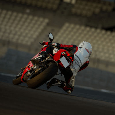 This image shows a close-up shot of a motorcyclist riding with Bridgestone sport tyres on their bike