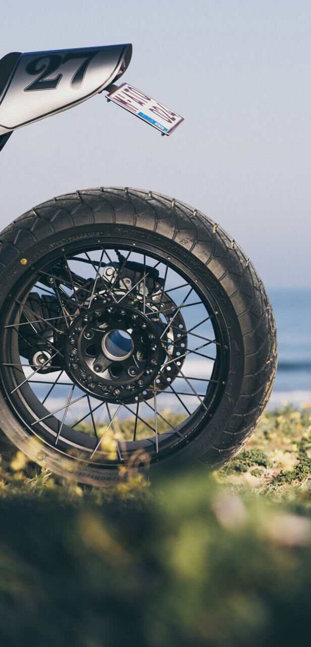 This image has a focus on a Brigestone Adventure motorcycle Tyre.