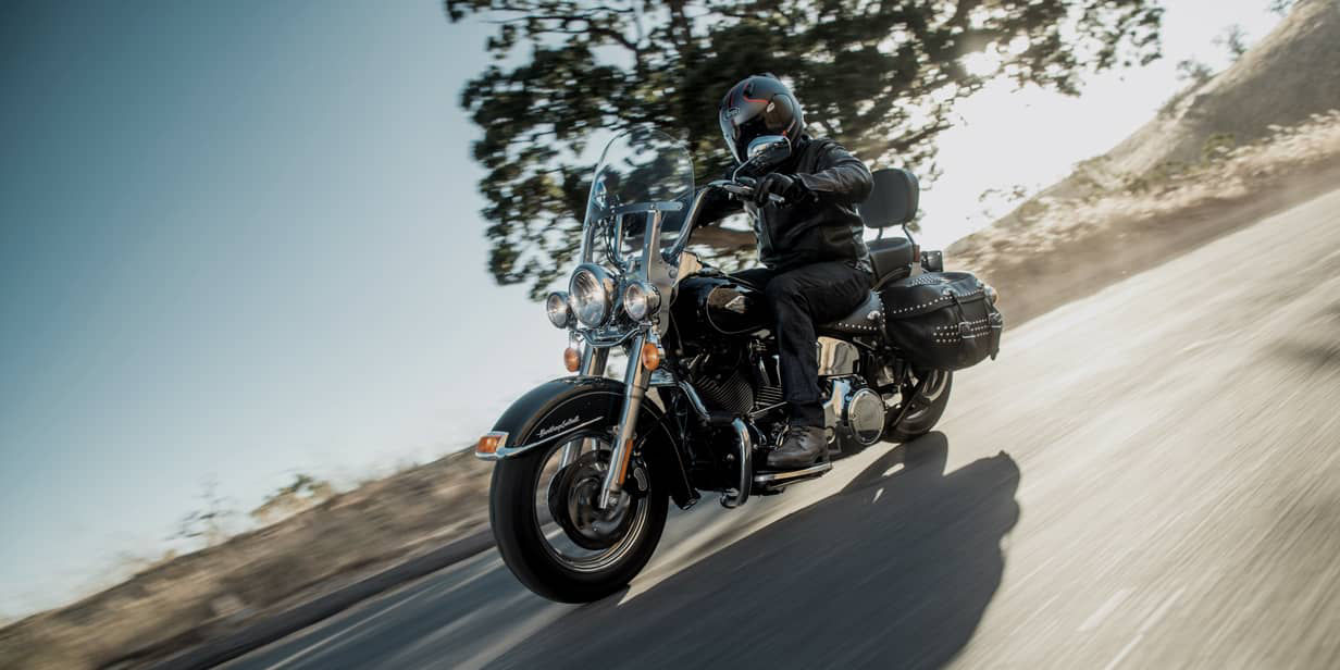 This image shows a front and side view of a motorcyclist with Bridgestone custom motorcycle tyres