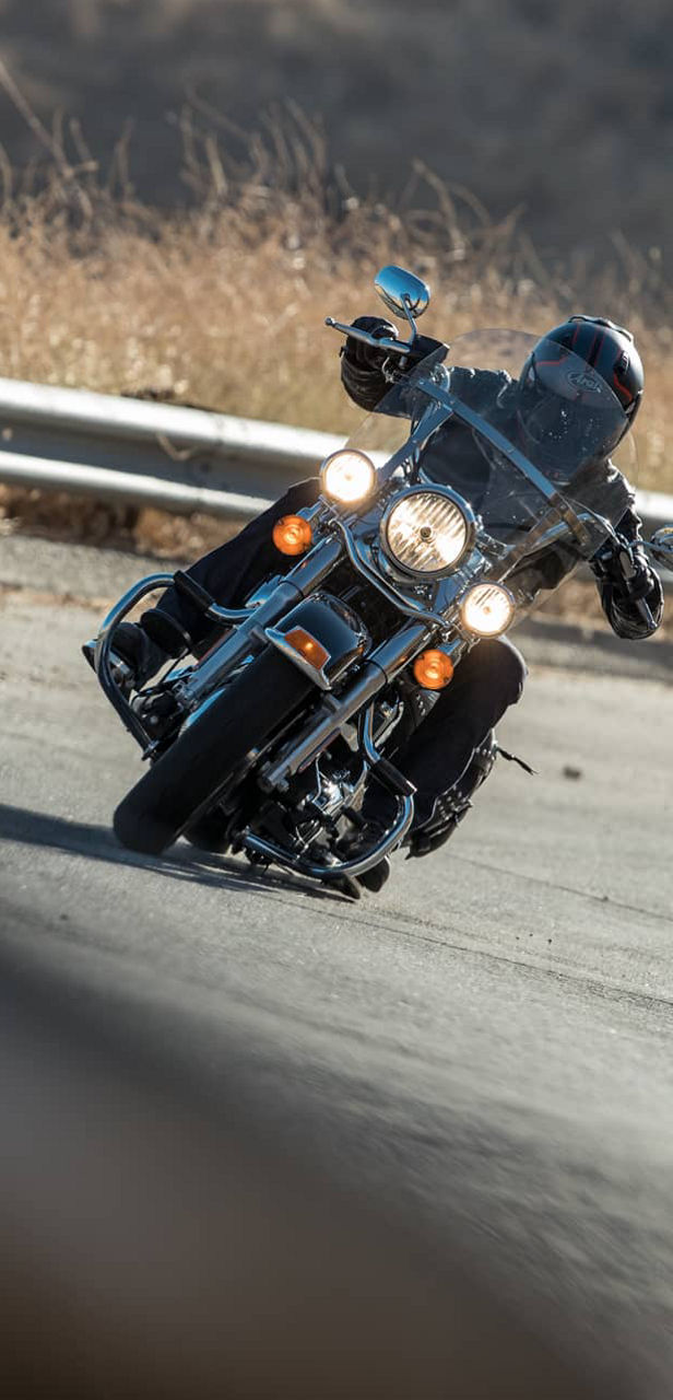 Na ovoj slici prikazan je pogled sprijeda na motociklista koji se vozi na prilagođenim gumama za motocikle Bridgestone