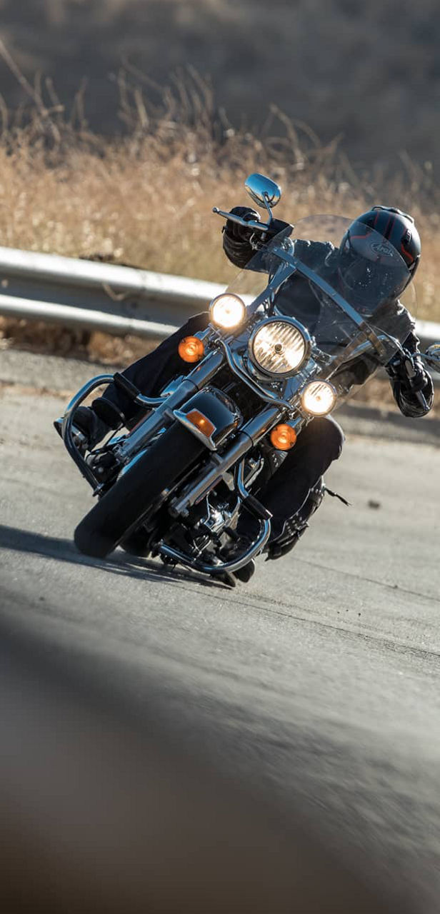 This image shows a front view of a motorcyclist riding with Bridgestone custom motorcycle tyres