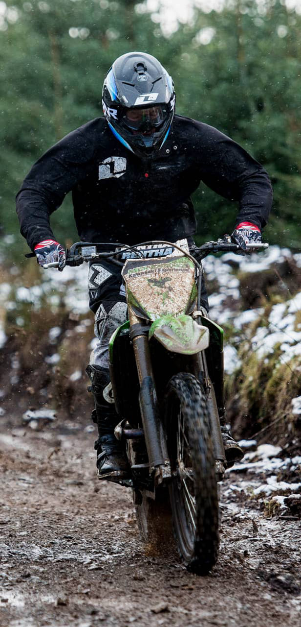 This image shows a front view of a motorcyclist riding with Bridgestone off road tyres