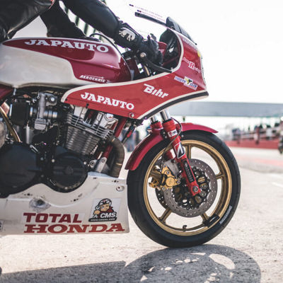 This image shows a Honda motorcycle closeup with Bridgestone tyres beloning to racers.