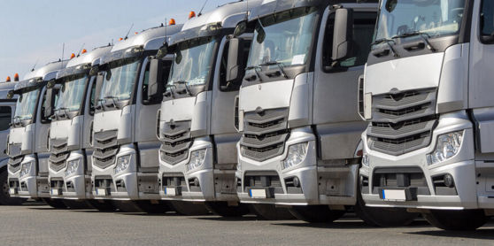 This image shows a line-up of commercial fleet vehicles that depend on Bridgestone OE fleet tyres.