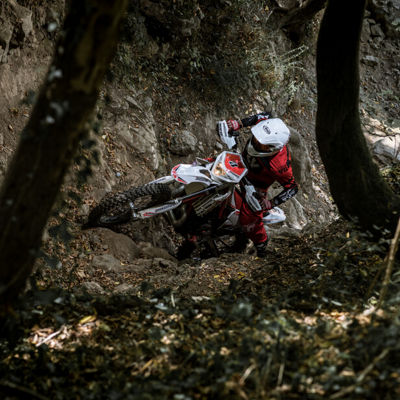 A motorcyclist going off road with his motorcycle and enjoying because of his Bridgestone tyres.
