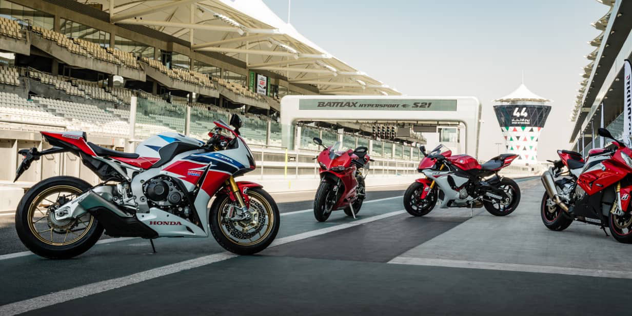 This image shows a range of different motorcycles with Bridgestone sport tyres on a race track