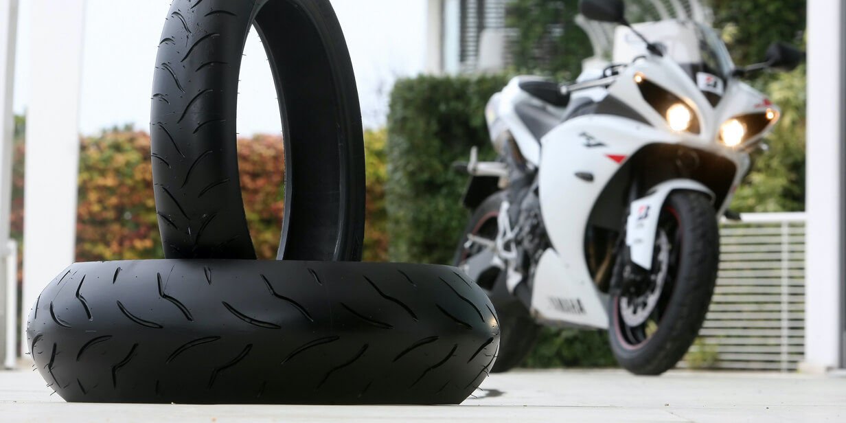 On this image we see a set of fresh Bridgestone Battlax tyres ready to put on a sportive motorcycle.