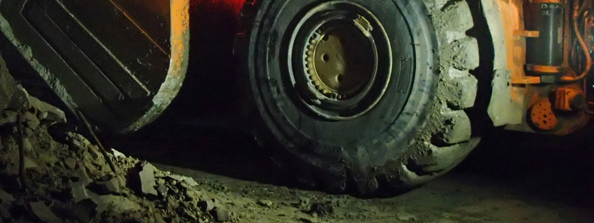 A large loader truck working in an underground mine