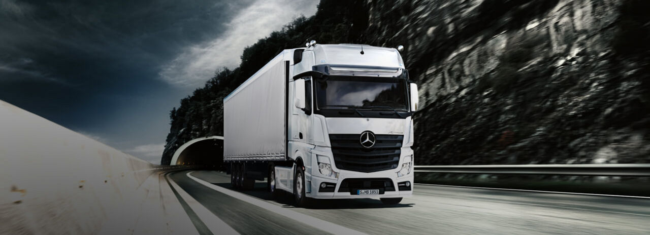 This image shows a Mercedes truck travelling down a highway with Bridgestone tyres. 