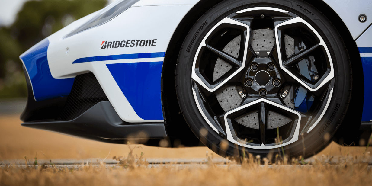 A side view of Potenza Race tyres on the front wheels of a racing tourer. 