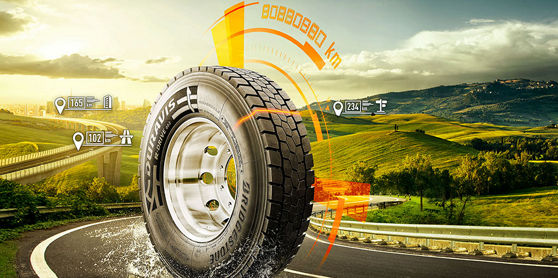 This image shows the Bridgestone Duravis R002 tyre driving down a highway with graphics that share its unique key features.