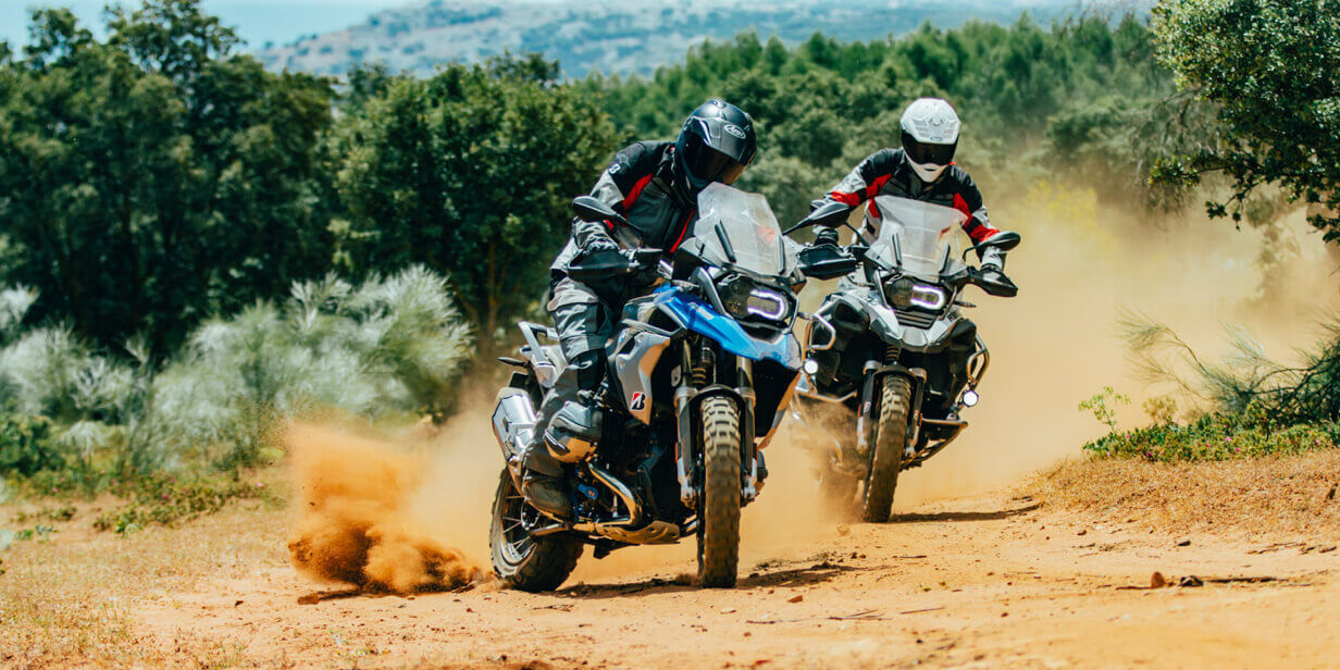 Adventure on this picture with two motorcyclists taking a corner in the sand on their Bridgestone Battlax Adventurecross tyres.