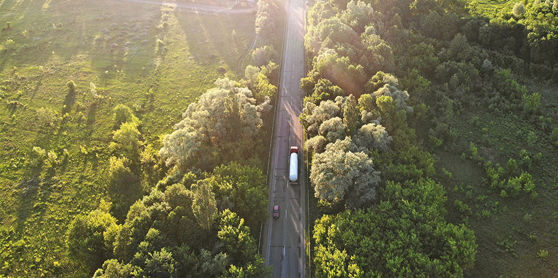 This image shows a bird's-eye view of a commercial fleet driving on a highway.