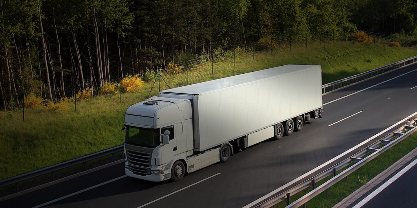 This image is a bird's-eye view of a commercial fleet travelling on a highway with Bridgestone highway tyres.